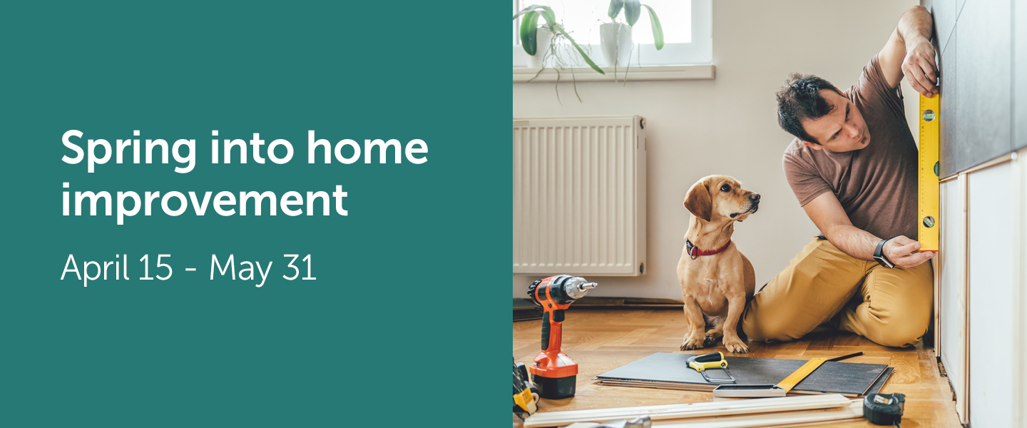 A dog watches a man doing construction on a home